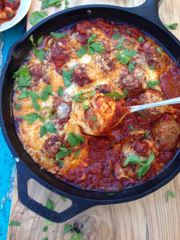 Cast Iron Skillet with Italian Ricotta Meatballs in Arrabiata Sauce on a Wooden Board Cast Iron Skillet with Italian Ricotta Meatballs in Arrabiata Sauce on a Wooden Board