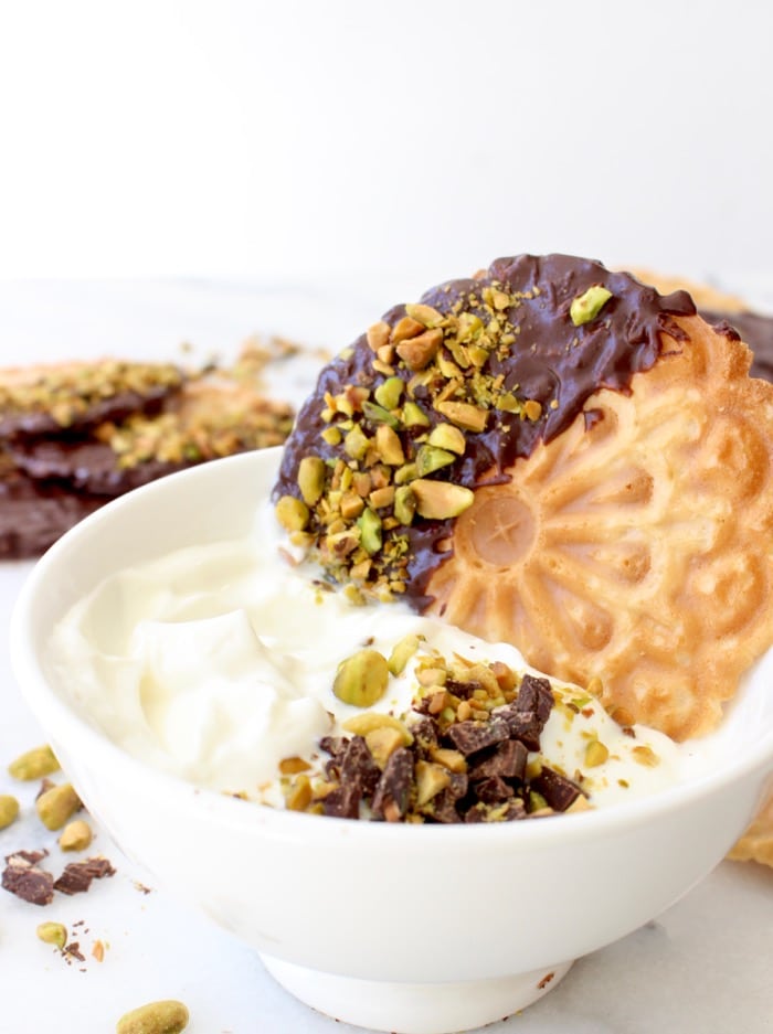 Bowl of Cannoli Cream Filling / Dip with Pizzelle on a Marble Table Bowl of Cannoli Cream Filling / Dip with Pizzelle on a Marble Table