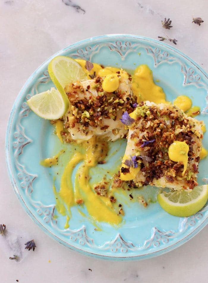 Blue Serving platter with baked fish in coconut pistachio crust with lime mango sauce. Blue Serving platter with baked fish in coconut pistachio crust with lime mango sauce.