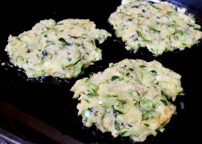 Zucchini Cakes Cooking in a Cast Iron Skillet Zucchini Cakes Cooking in a Cast Iron Skillet