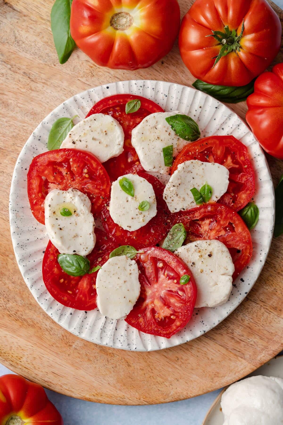 Vegan Caprese salad with homemade mozzarella, tomatoes and basil. Vegan Caprese salad with homemade mozzarella, tomatoes and basil.